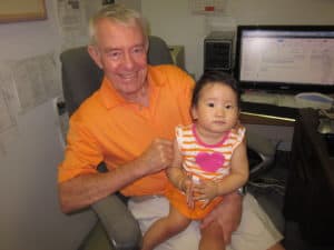 Realtor Tom Delmore & Granddaughter Madison busy working on real estate in matching orange outfits